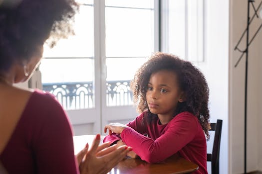 A parent and child sitting together, having an open conversation